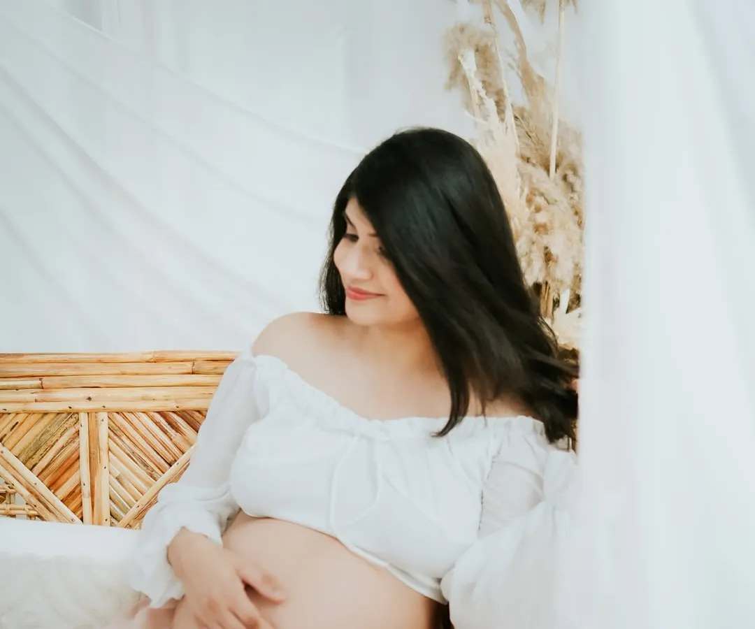 Embracing the serene and dreamy side of motherhood. This studio session uses soft lighting and flowing fabrics to create a calm, beautiful portrait that focuses on the peaceful anticipation of meeting your little one.