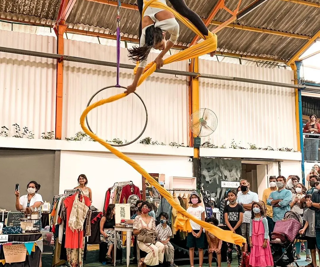Experience the thrill of defying gravity. This shot captures the grace and strength of an aerial silk performance during one of our community events. Our workshops make this beautiful art form accessible to everyone, regardless of experience.