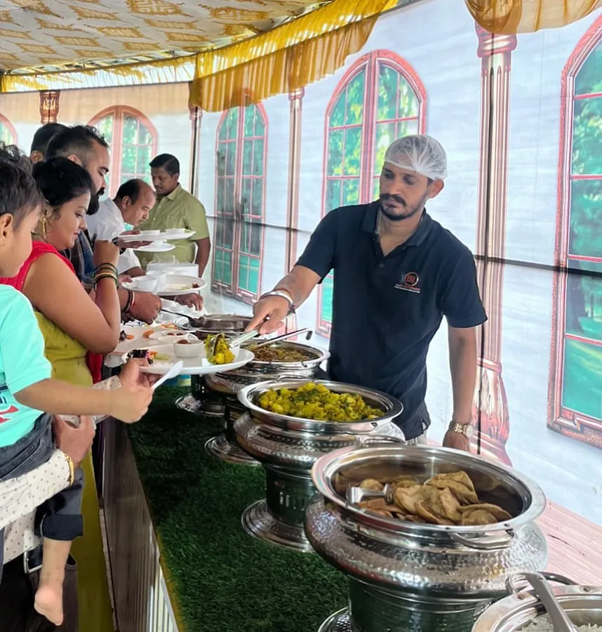 My team provides attentive service, ensuring every guest enjoys a hot and fresh pure vegetarian meal. Here, we are serving a delicious spread at a corporate lunch gathering.