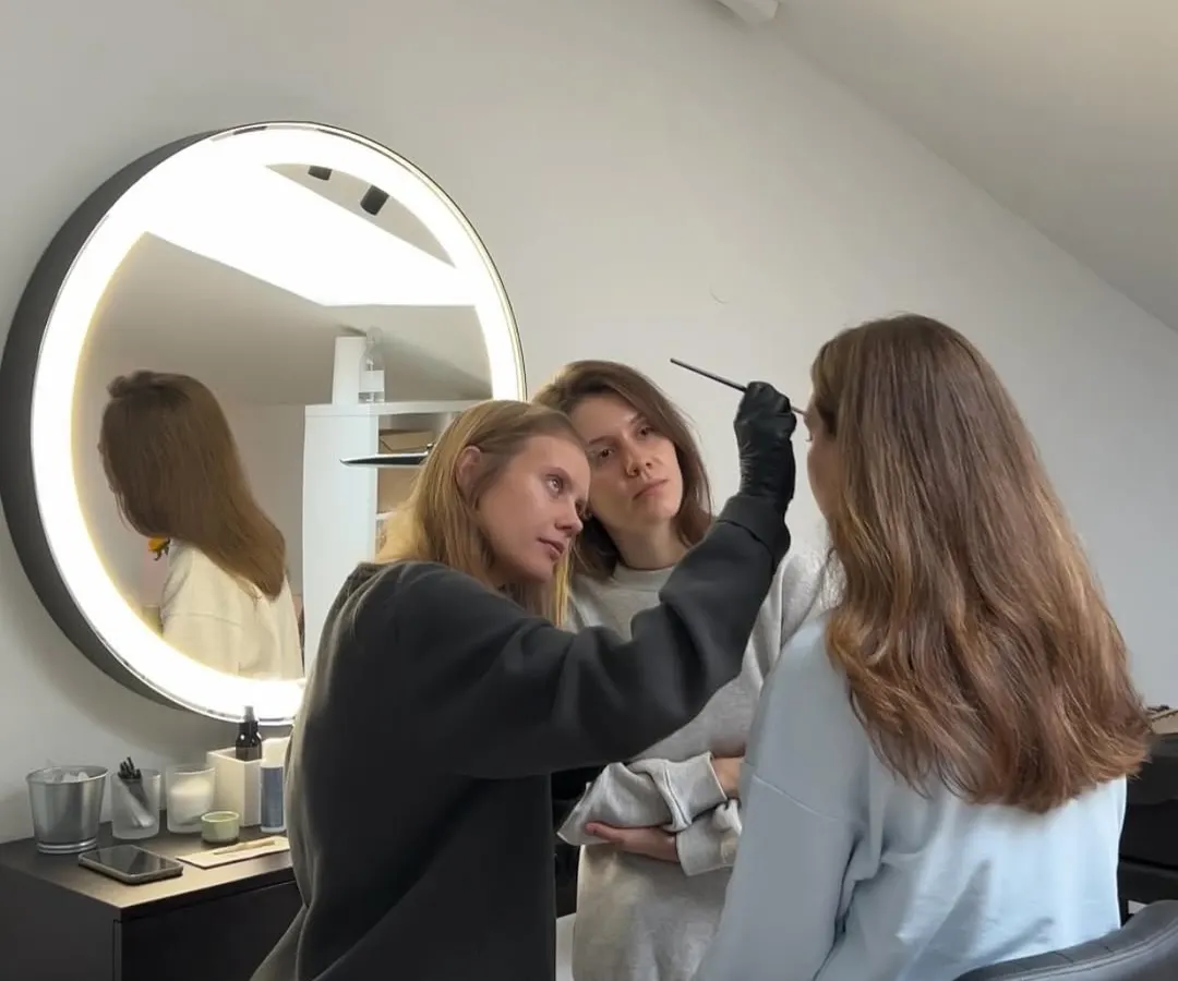We keep our classes small to give you our full attention. In this photo, an instructor is demonstrating the correct brush technique for eyebrow coloring, while a student observes closely. This personalized approach is key to building confidence and skill.