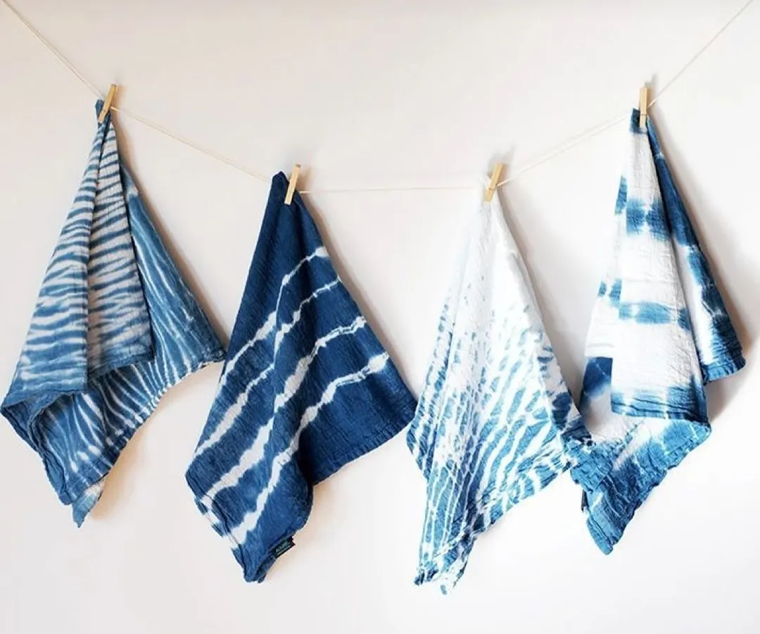 Here are some examples of my custom indigo dyeing work, showcasing different Shibori tie-dye techniques. Each piece is handcrafted on natural fabric, resulting in unique patterns ranging from deep ocean blues to crisp whites. These are perfect for sustainable fashion collections.