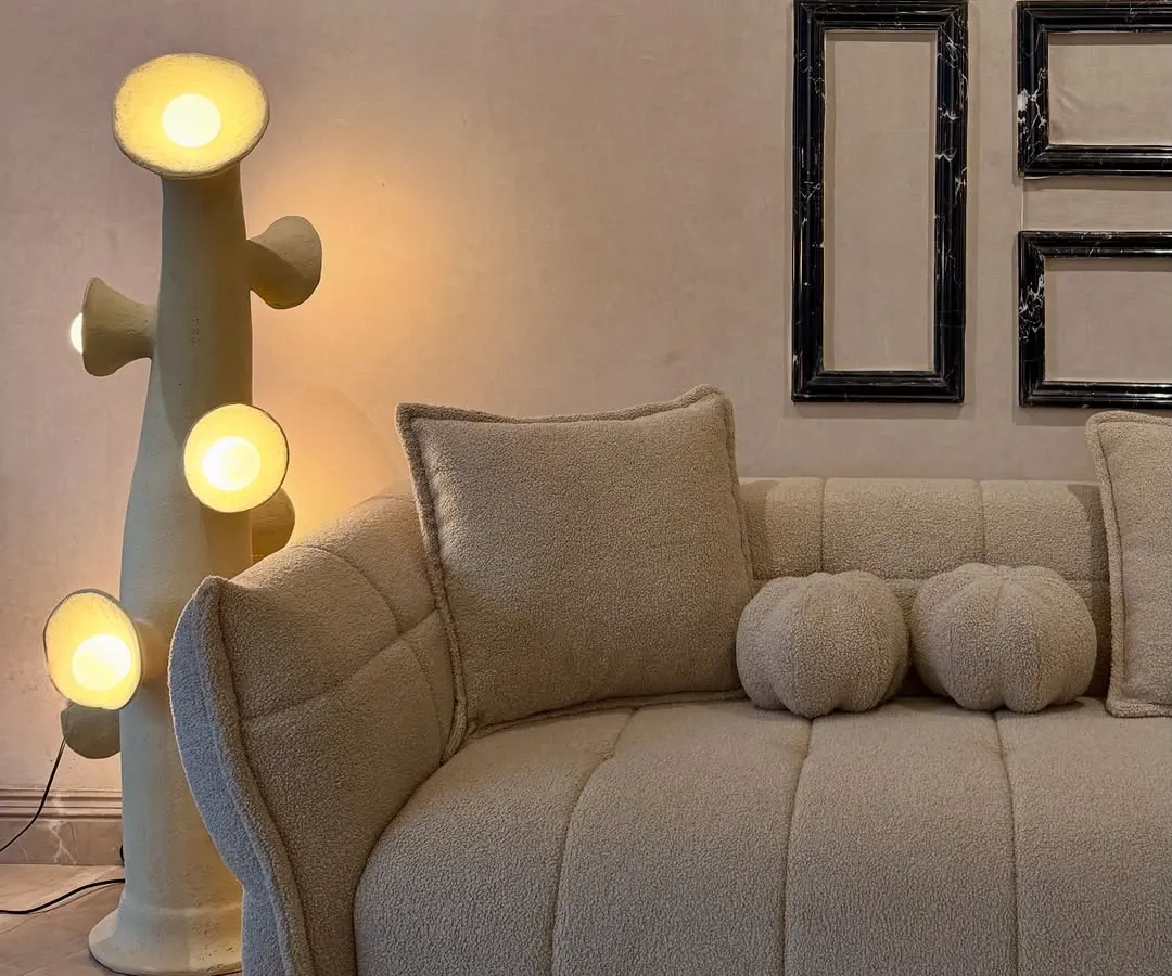 This is where sculptural form meets ultimate comfort. I designed this living room setting with a flange-trim bouclé sofa and squishy cushions, paired with organic lighting to create a perfect visual rhythm. It’s a great example of the modern, textured, and snug furniture you can find in my collection.