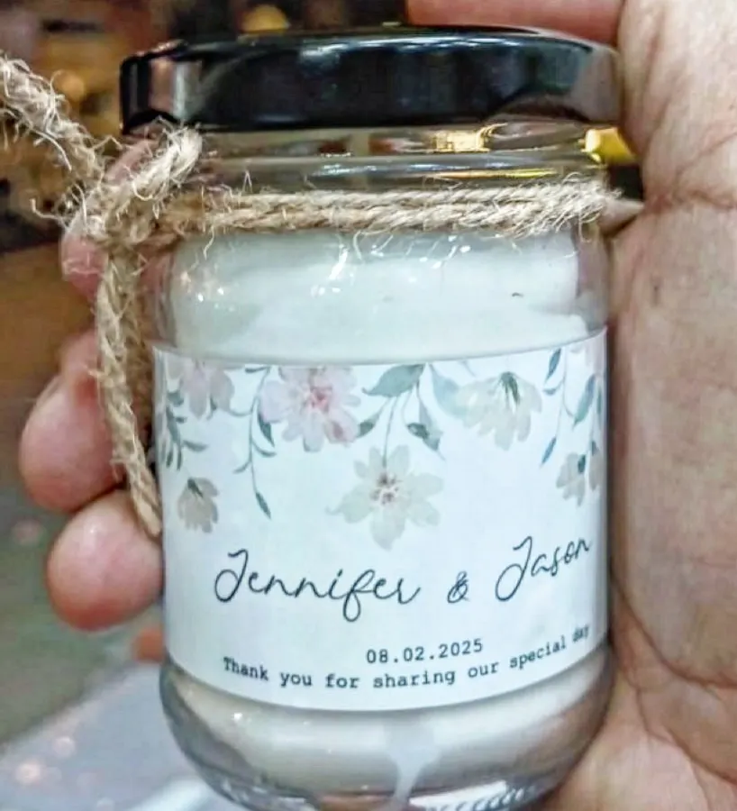 A close-up of a scented jar candle I made as a wedding favor. I can print your names, wedding date, and a thank you message on a custom label, making it a memorable return gift for your guests.