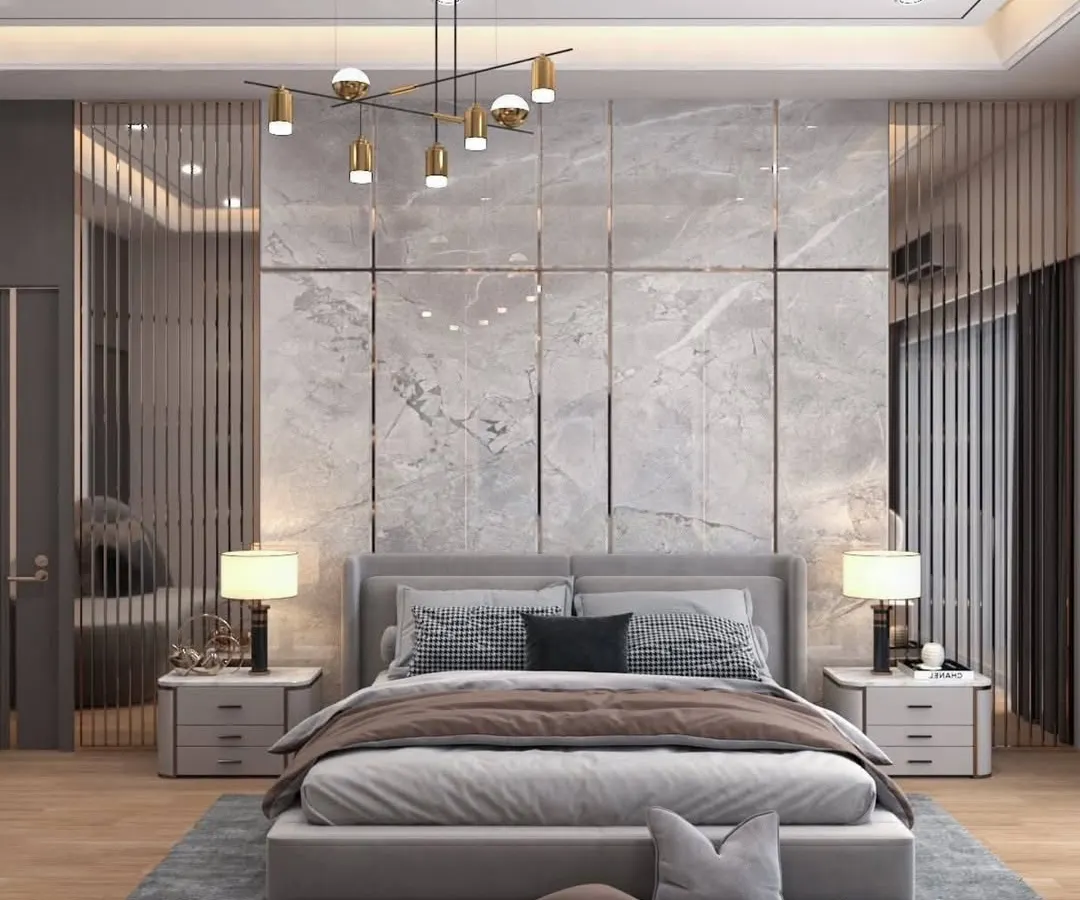 This master bedroom is a sanctuary of modern elegance. We used a floor-to-ceiling marble-finish panel as the headboard, accented with polished metal inlays and flanked by vertical fluted glass panels to create depth and texture. The contemporary chandelier and matching bedside lamps provide layered, ambient lighting, completing this tranquil and luxurious retreat.