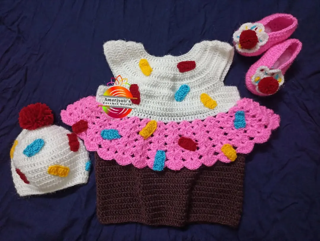A sweet cupcake-themed dress set, complete with a sprinkle-covered hat and matching pink shoes. This is one of my most requested custom crochet baby outfits, ideal for making any day feel like a celebration.
