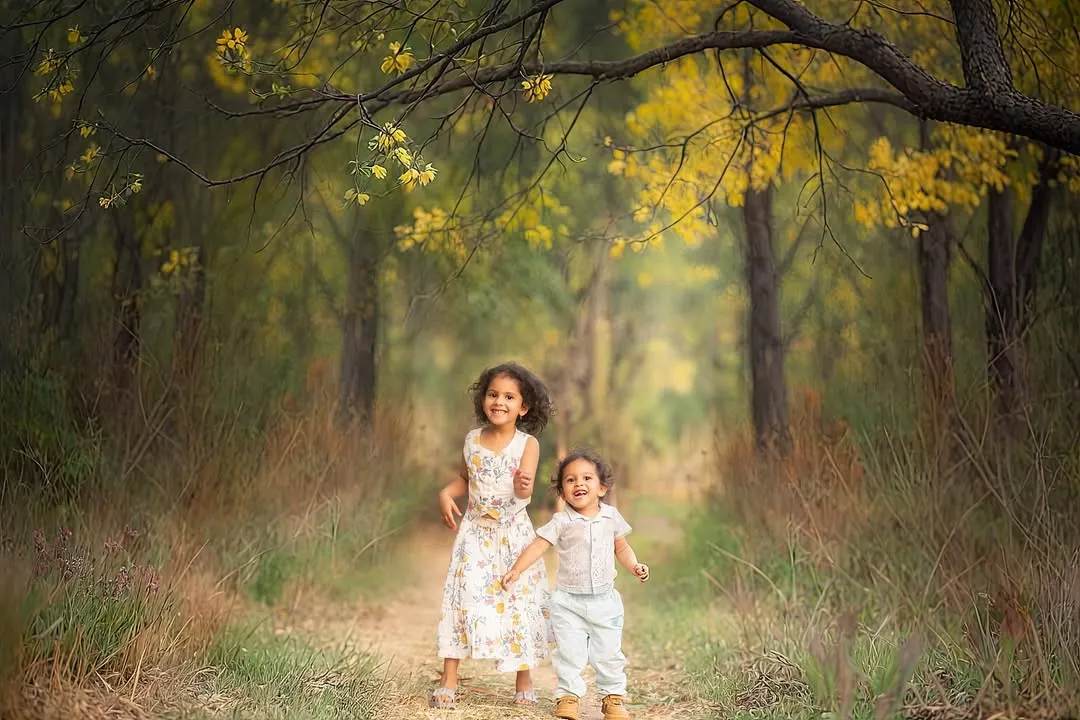 We love capturing the pure, unfiltered joy of childhood. This outdoor session in a beautiful wooded area was all about letting these siblings run, play, and just be kids, resulting in authentic, story-filled photographs.