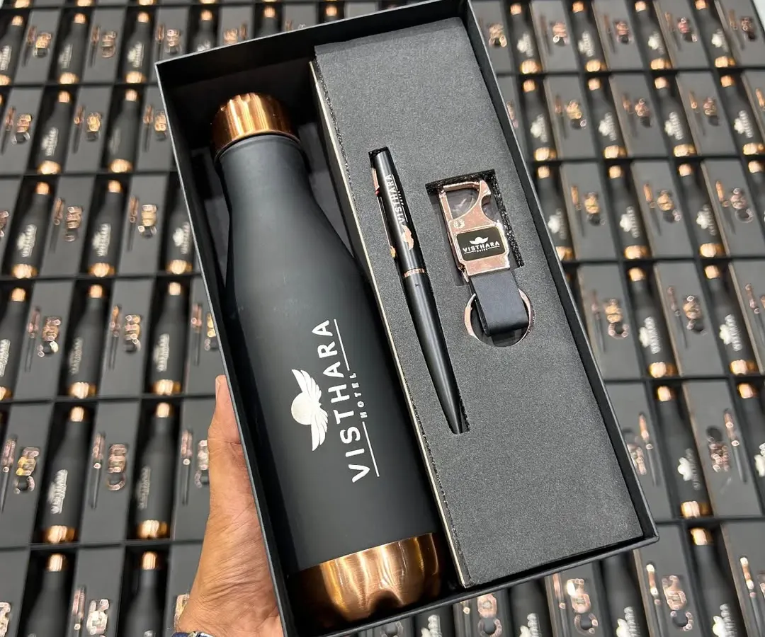 I handle large bulk orders for major brands like Visthara Hotels. This executive gift set features a matte black and rose gold temperature bottle, a matching pen, and a custom keychain, all elegantly boxed and ready for distribution.