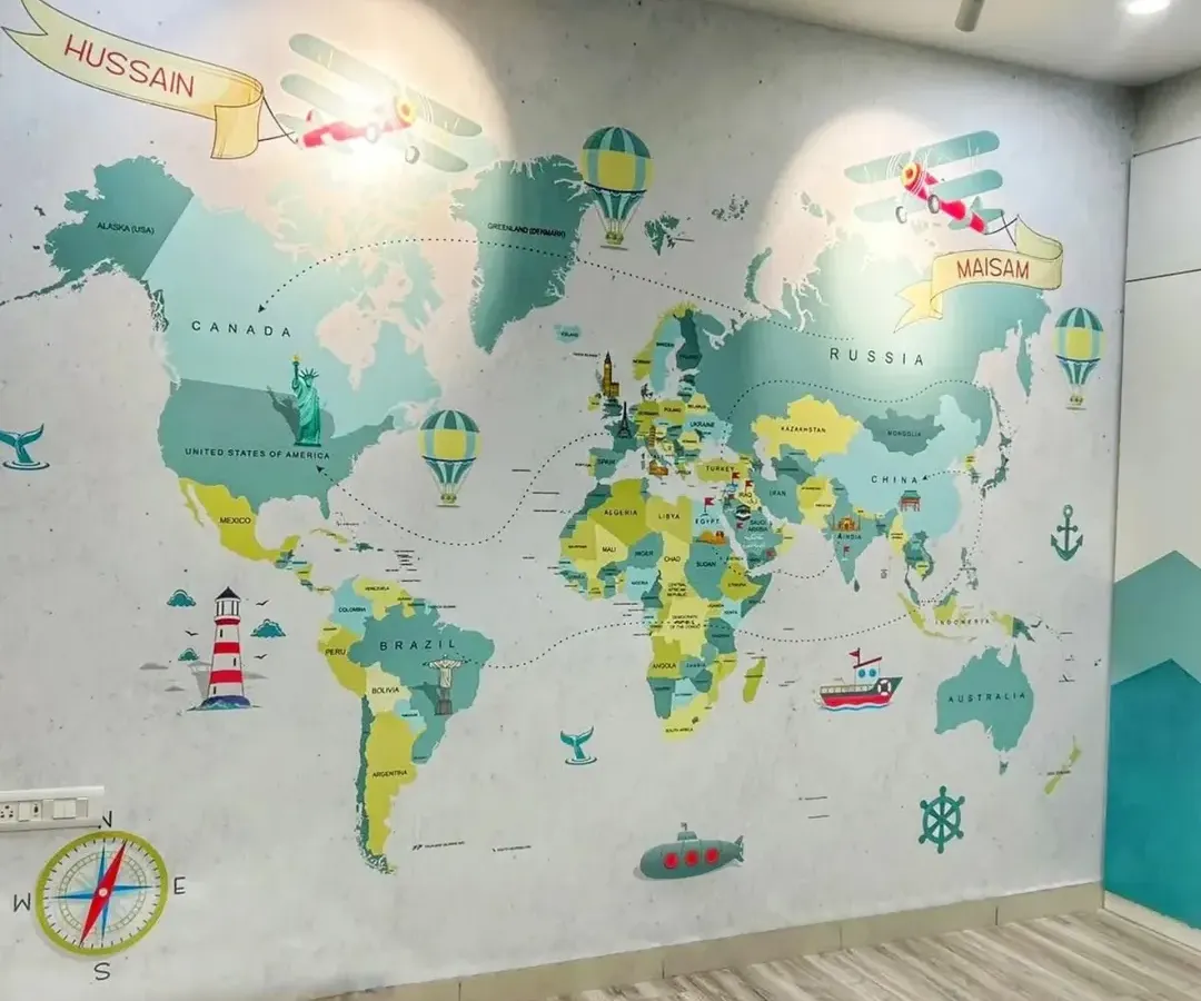 We brought a sense of adventure to this kids' room with a personalized world map wallpaper. The design is both educational and playful, featuring custom name banners for 'Hussain' and 'Naisam', making it a unique and engaging feature wall for young explorers.