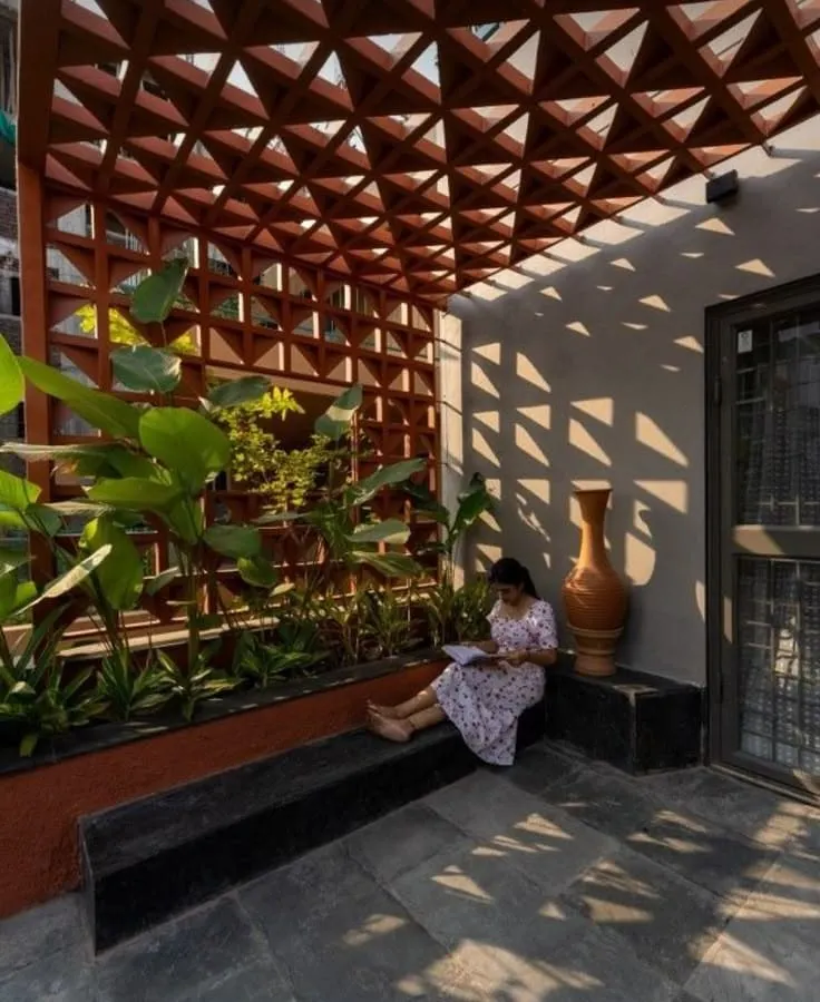 We created this tranquil corner for a client who wanted a peaceful reading spot. The custom terracotta jali pergola casts beautiful shadows, creating a dynamic and serene atmosphere throughout the day, complemented by a built-in planter.
