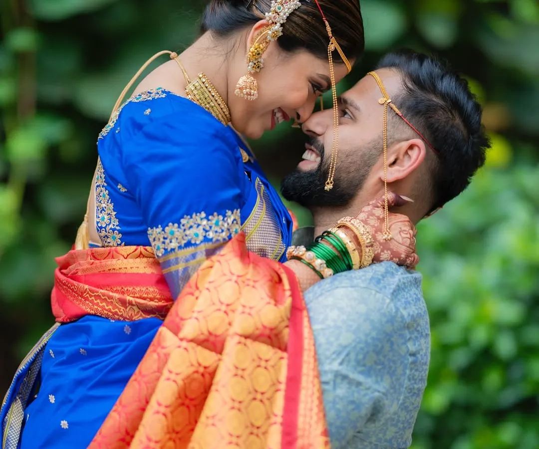 A moment of pure joy and connection. We love capturing these unscripted, happy lifts that show the couple's personality, like this one from a beautiful Maharashtrian wedding.