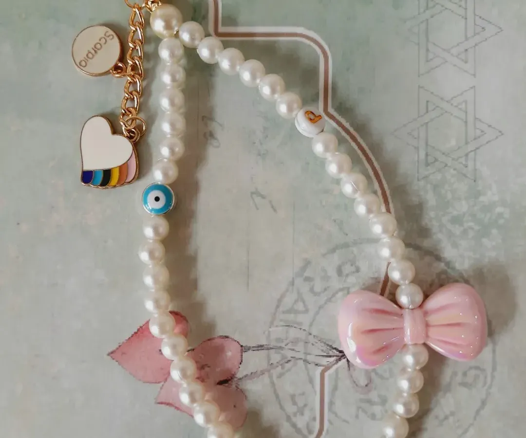 This is what I mean by making it personal. I created this custom pearl bag charm for a Scorpio, complete with a pastel bow, an evil eye for protection, and a rainbow heart. We can design one that tells your story, too.