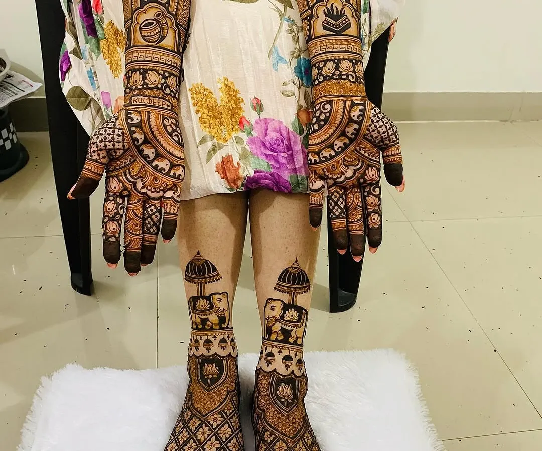 A complete bridal mehndi set for a truly royal look. This design covers both hands and feet with coordinated patterns, featuring traditional elephant motifs, intricate jaal work, and auspicious symbols for a cohesive and stunning bridal look.