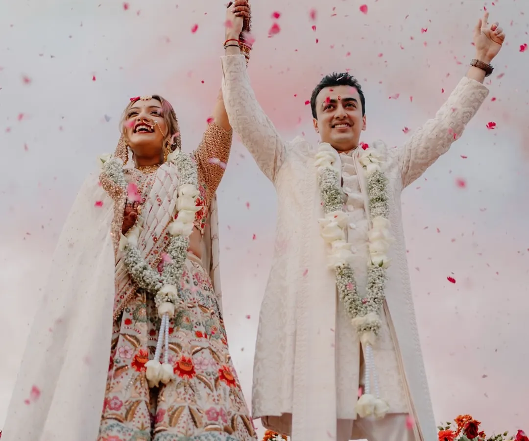 The pure, unscripted joy of a couple celebrating their union under a shower of petals. This is the kind of vibrant, emotional moment I live to capture, where happiness is the most beautiful detail.