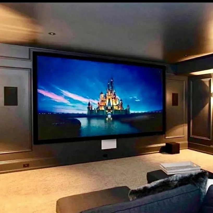This installation showcases the visual centerpiece of a high-end presentation space: a massive, fixed-frame projector screen. Paired with a true 4K projector, it delivers breathtakingly sharp and vibrant images, ensuring that presentations and video content are displayed with maximum impact, even in rooms with ambient light.