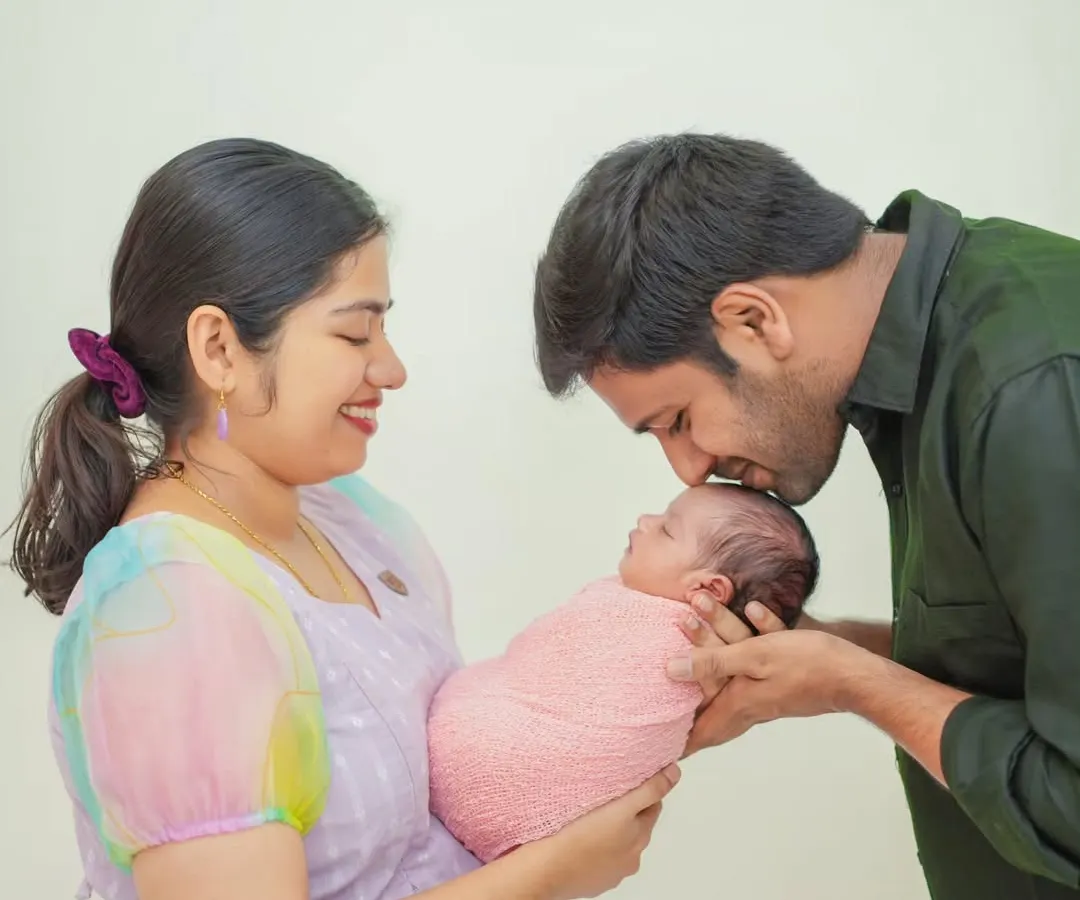 Capturing the pure love and connection in your family's first portrait is essential. In my studio, I guide families into natural, heartfelt poses that result in timeless images like this one.