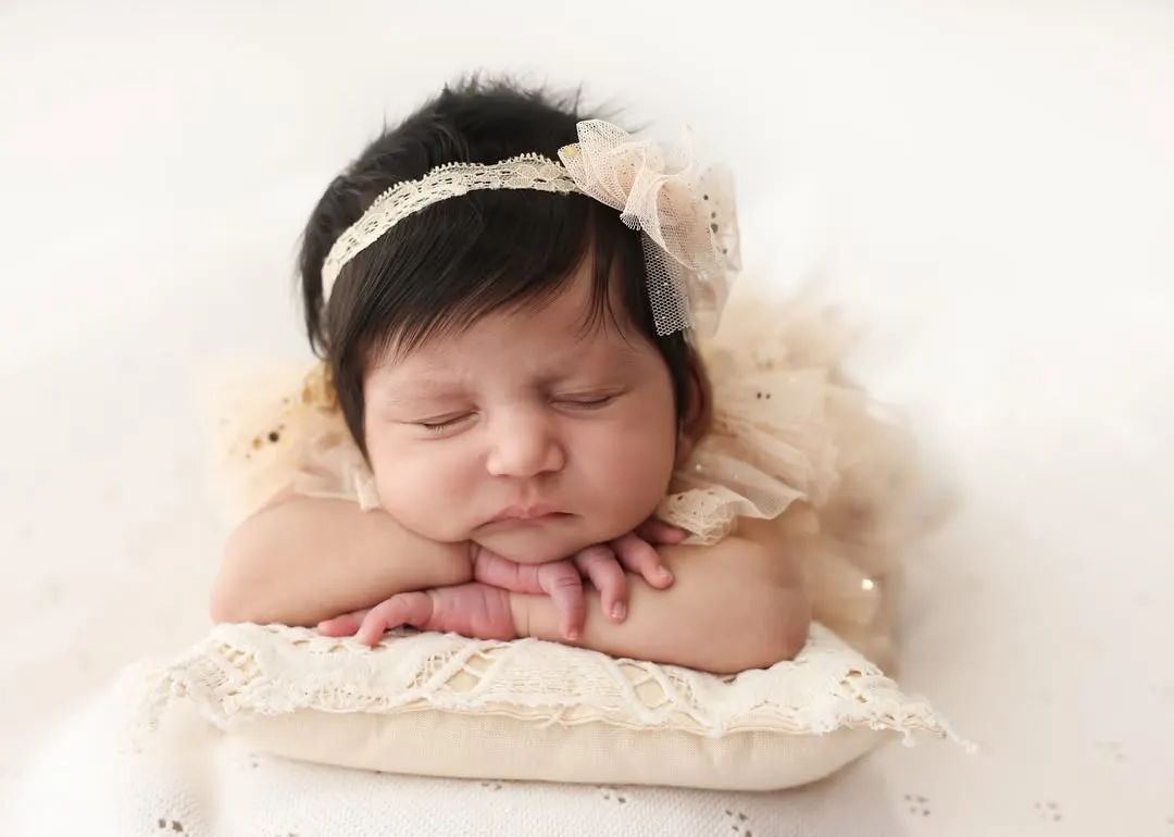 The quiet perfection of a newborn. I focus on capturing those tiny, delicate features, like the curve of their cheek and the peacefulness of their sleep. This classic head-on-hands pose is a timeless way to remember just how small they once were.