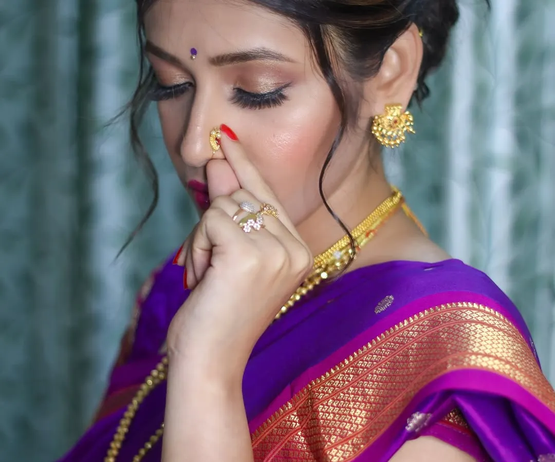 A close-up of a classic Maharashtrian bridal look. I focused on creating a soft, shimmery eye that complements the traditional nath and gold jewelry, ensuring the bride feels both authentic and beautiful.