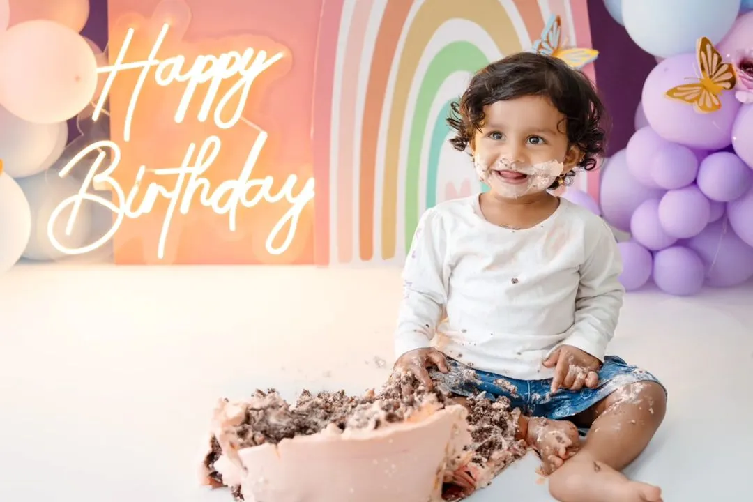 The pure joy of a first birthday cake smash! This little one is having the best time with her rainbow-themed celebration. I love capturing these messy, happy, and unforgettable moments.