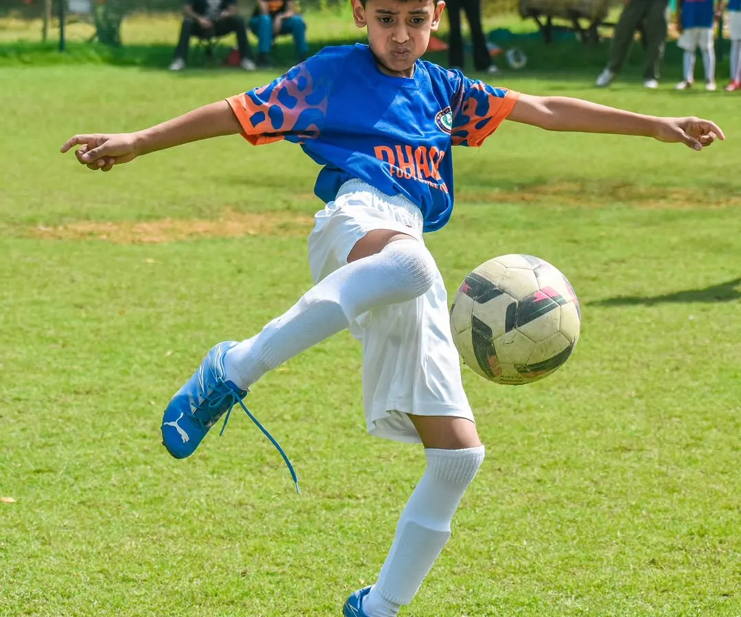 Here, we focus on mastering the fundamentals. This young player demonstrates excellent ball control and kicking technique, skills we build in every session.
