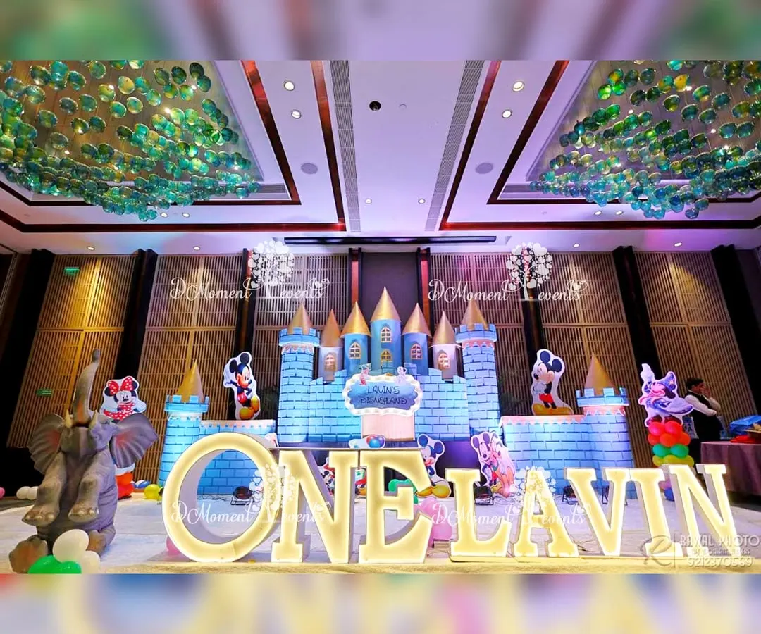 For the ultimate fairytale experience, I build immersive stage setups like this grand Disneyland castle. Complete with character cutouts and illuminated lettering, this backdrop for a first birthday party creates a truly royal photo opportunity and a centerpiece for the entire event.