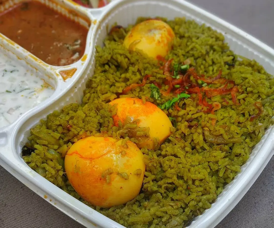 Here’s a closer look at my Thuppangadi Egg Biriyani, served in our convenient takeaway meal tray. The fragrant, green chili and pepper-spiced rice is paired with perfectly cooked eggs, along with my homemade salan and cooling raita.