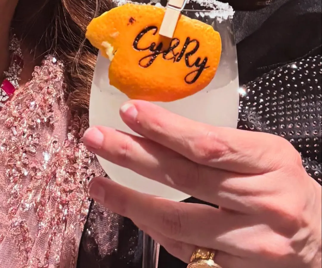 It's the personal touches that make an event unforgettable. We love creating unique details like this custom-stamped orange peel garnish, featuring the couple's initials, to make their signature cocktail truly their own.