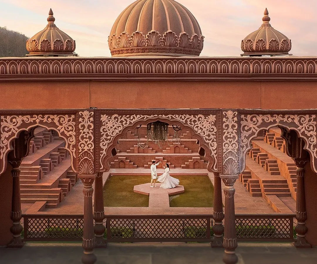 Using a drone, I can capture your love story from a grand perspective. This shot at Sets in the City shows how we can create a truly epic and royal pre-wedding portrait that feels like a scene from a movie.