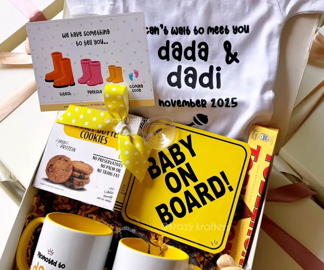The sweetest way to share the best news! This pregnancy announcement hamper for the 'dada' and 'dadi' to be is filled with personalized mugs, a 'Baby on Board' sign, and a custom onesie to make the moment truly special.