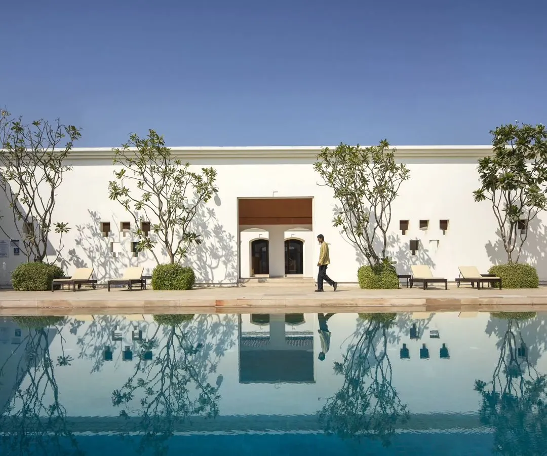 The serene poolside of our hotel project in Bodhgaya, designed as a tranquil sanctuary that encourages reflection. The architecture harmonizes with the water, creating a seamless experience of peace.