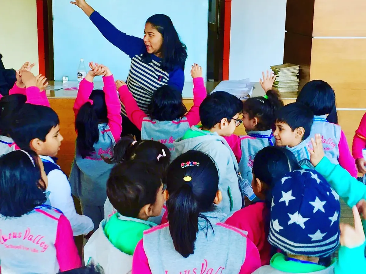 Here, during a session at a local school, I'm guiding the children through a new movement. My classes are designed to be interactive and fun, helping kids build body awareness and learn to manage their energy in a positive, healthy way.