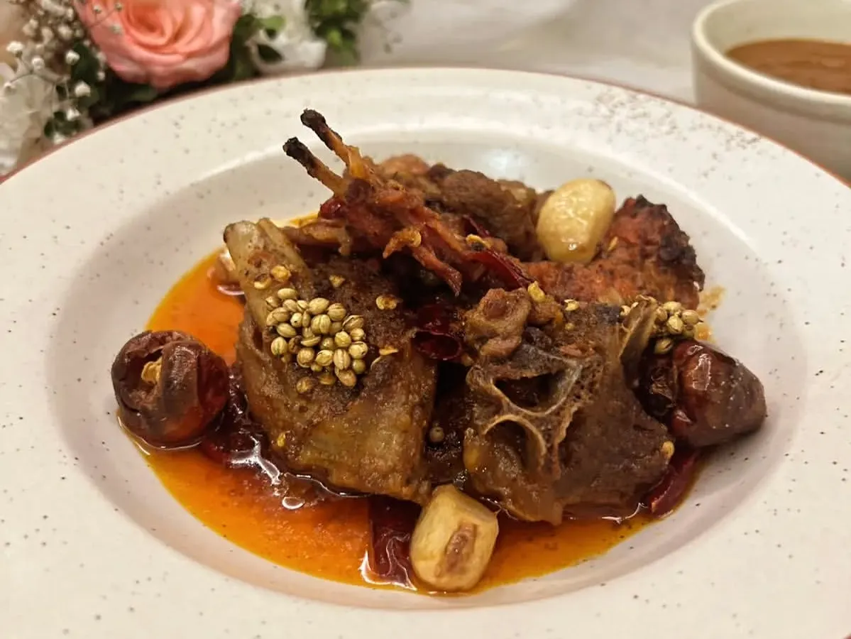 Experience the fiery taste of Rajasthan with our Junglee Maas. This spicy dry lamb curry is slow-cooked in A2 cow ghee with confit garlic and boriya chili, creating a bold and unforgettable flavor.