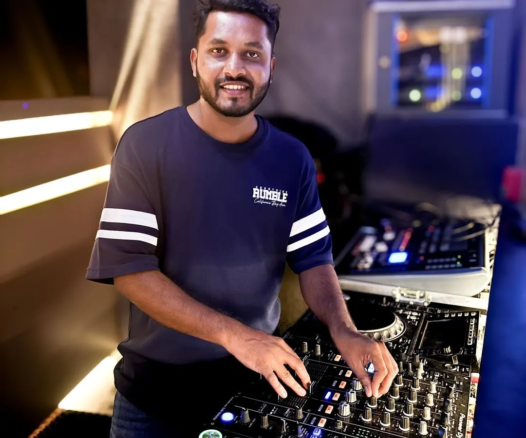 Here I am in my element, ready to spin the tracks that will make your event a hit. I love connecting with the crowd, and this shot captures me getting ready for another great night of music in Bangalore.