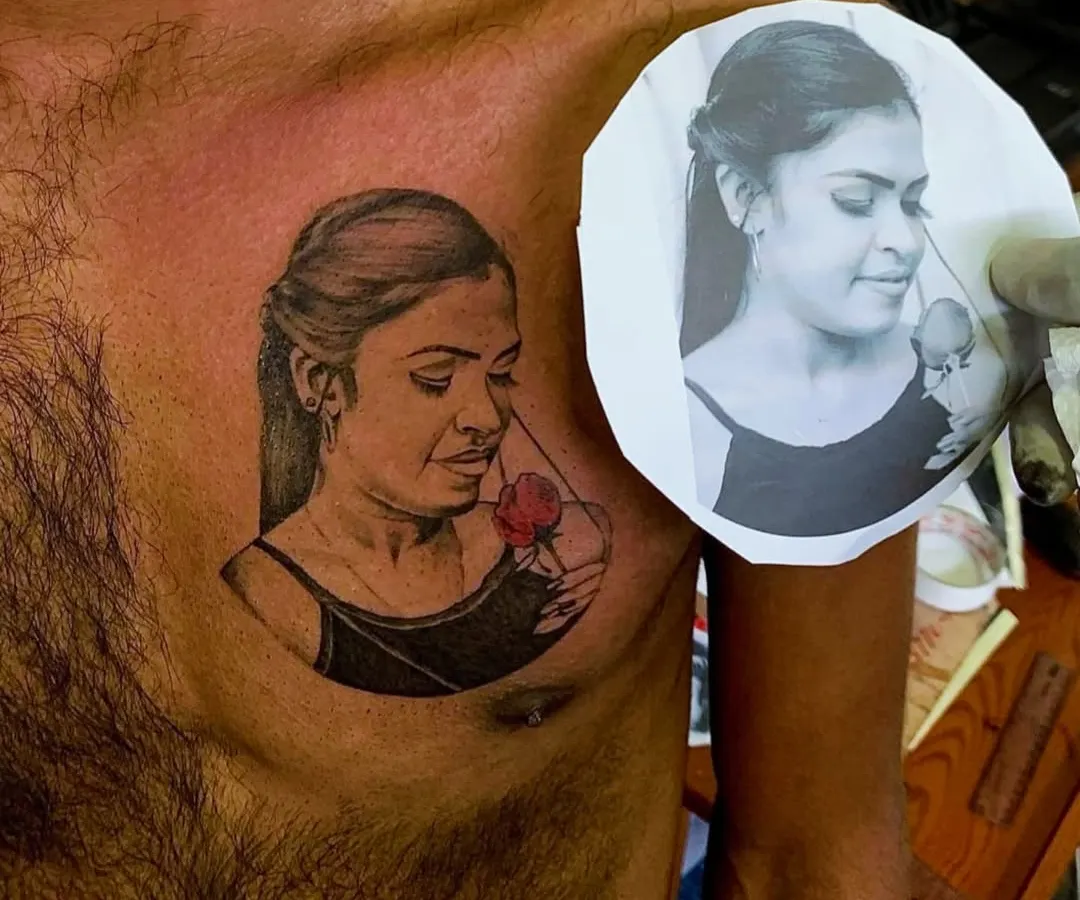Creating a realistic portrait tattoo requires precision. Here, you can see the final tattoo on the client's chest placed next to the original reference photograph, showing how I accurately capture the likeness and emotion of the subject.