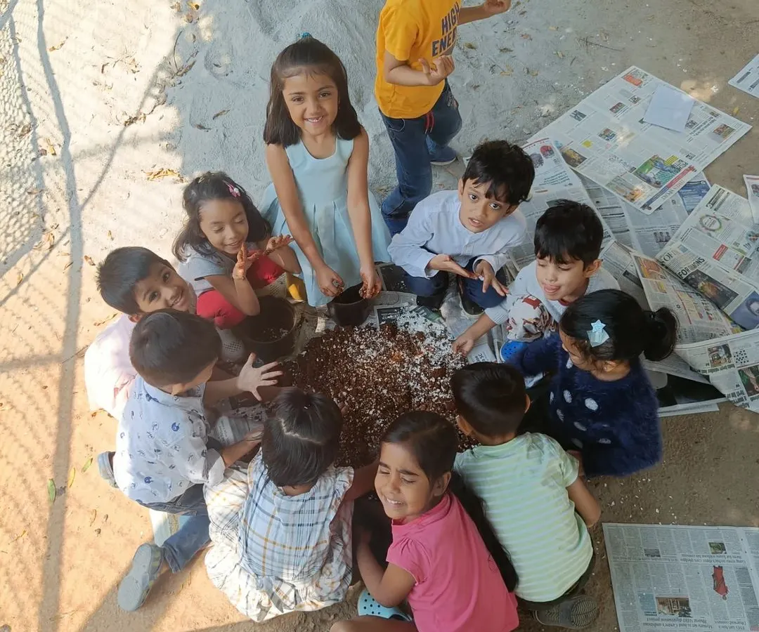 We believe in learning through doing. Children get their hands dirty, mixing soil and crushed eggshells to enrich the earth for planting, a wonderful sensory activity that teaches them about nature's cycles.