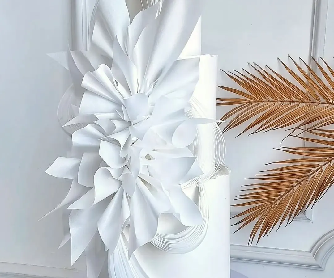 Imagine creating wedding cakes this elegant and flawless. This three-tiered white architectural cake showcases the modern wafer paper techniques and sharp edges you'll master in our advanced workshops.