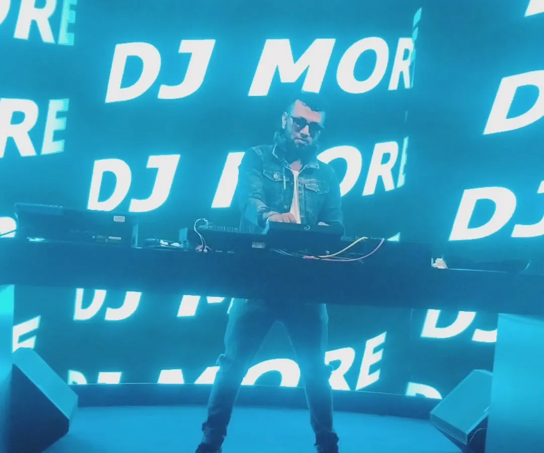 In my element, commanding the stage with my name up in lights. This is the energy and presence I bring to large-scale events, making sure every beat hits with maximum impact.