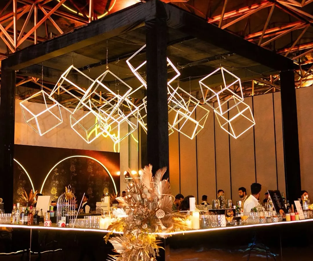 We transform spaces with dramatic lighting and bold structures. For this sangeet, we designed a central bar with a custom installation of illuminated geometric cubes, creating a high-energy focal point that was both a functional bar and a piece of modern art.
