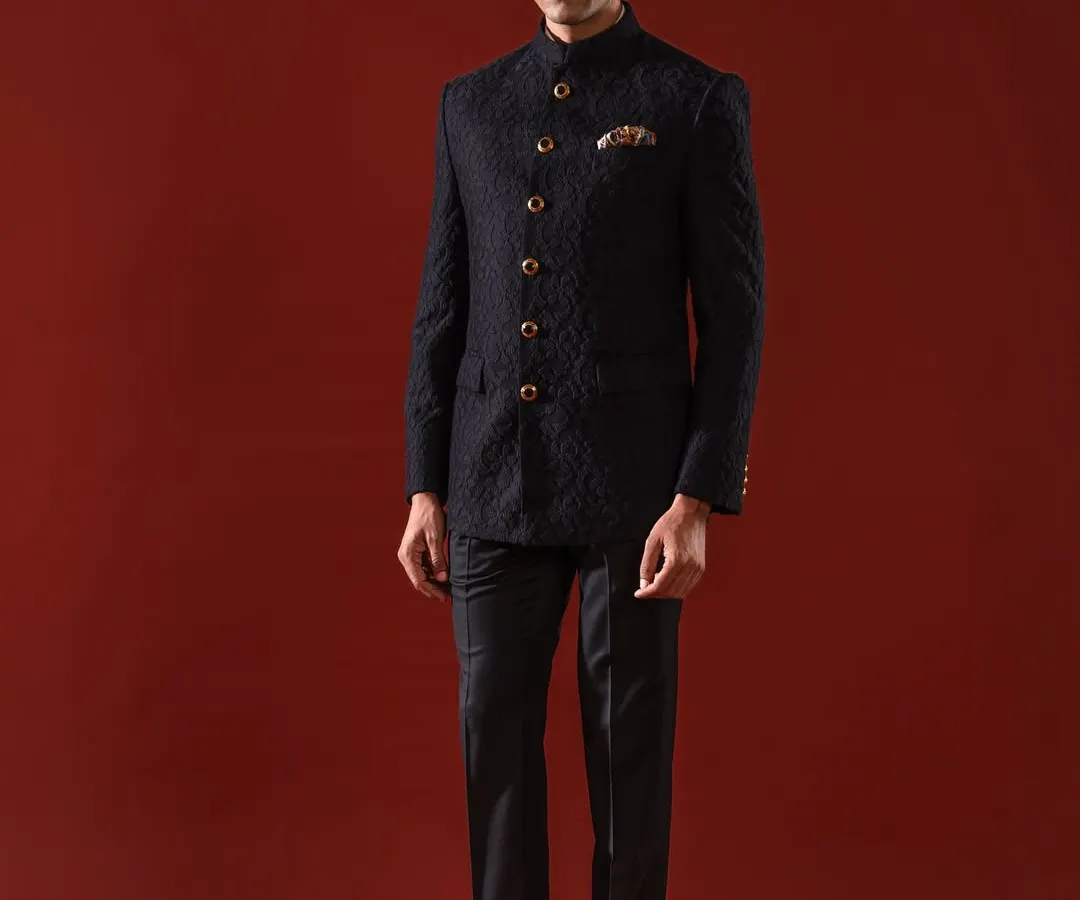 The quintessential Bandhgala, presented in a deep, textured black. This ensemble is the epitome of sharp, modern royalty, featuring a flawless bespoke fit and ornate buttons that provide a touch of classic distinction for any formal occasion.