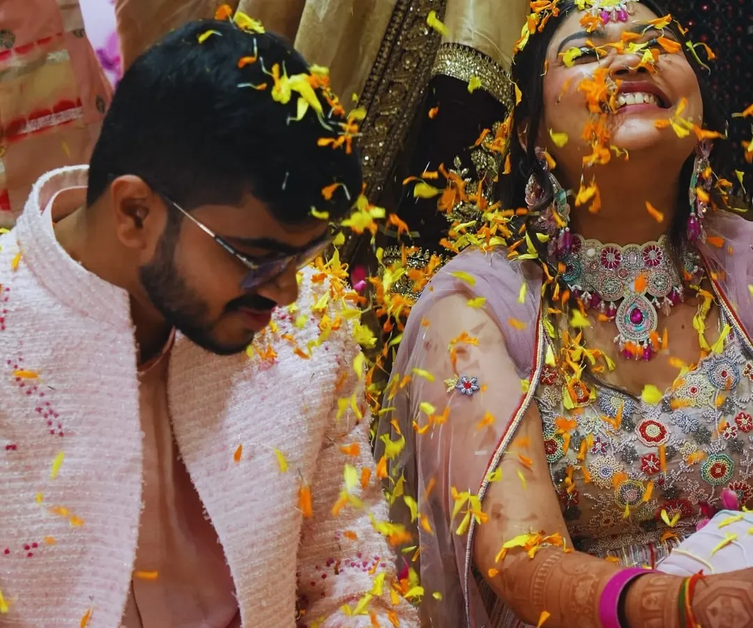 A moment of pure, unscripted joy during a 'Phoolon ki Haldi'. We believe the best memories are made when you're surrounded by love, laughter, and a shower of flower petals.