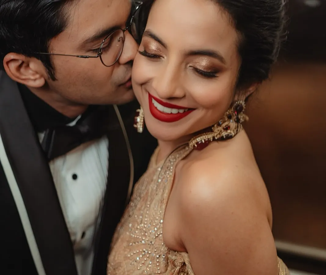 A close-up of Tessa's reception glam. We went for a classic bold red lip and shimmering golden eyes that caught the light beautifully. It’s a timeless look that feels both elegant and celebratory, perfect for dancing the night away.