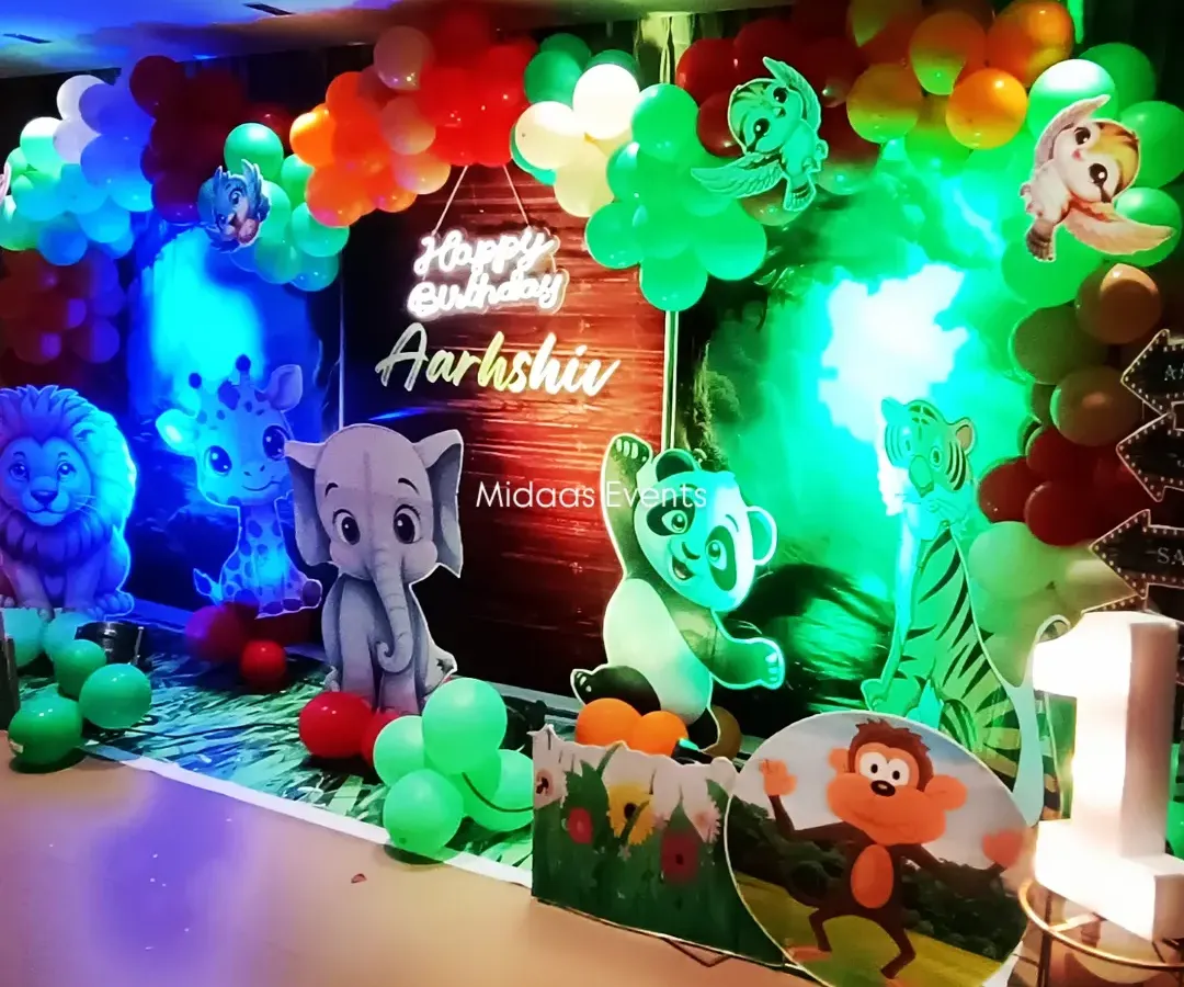 This jungle-themed birthday setup is a perfect example of how I bring a concept to life. I used a mix of elements like a personalized neon sign for the birthday boy, Aarshiv, cute animal cutouts, and a lush balloon arch to create an immersive and photo-ready backdrop.