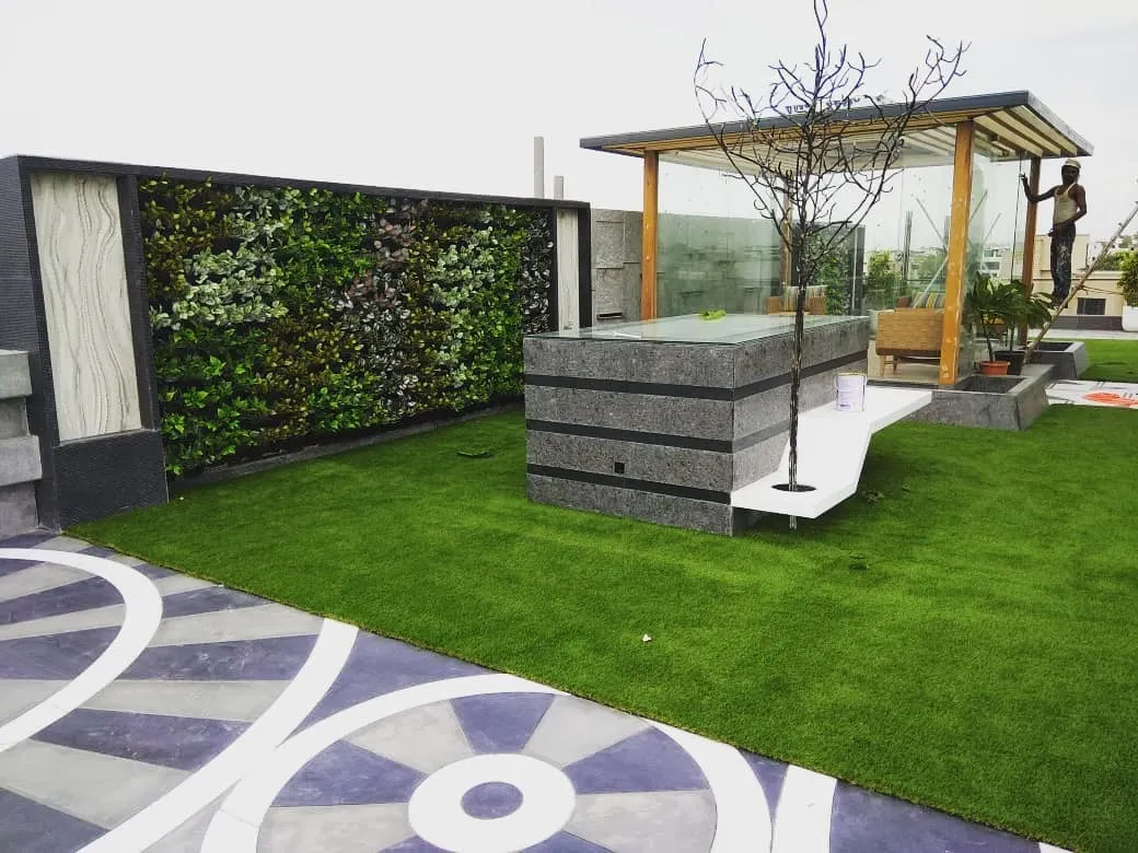 We designed this complete terrace makeover to create a functional and beautiful rooftop escape. The project features high-quality artificial turf for a soft lawn feel, a custom artificial vertical garden for privacy, and a shaded gazebo area for relaxation.