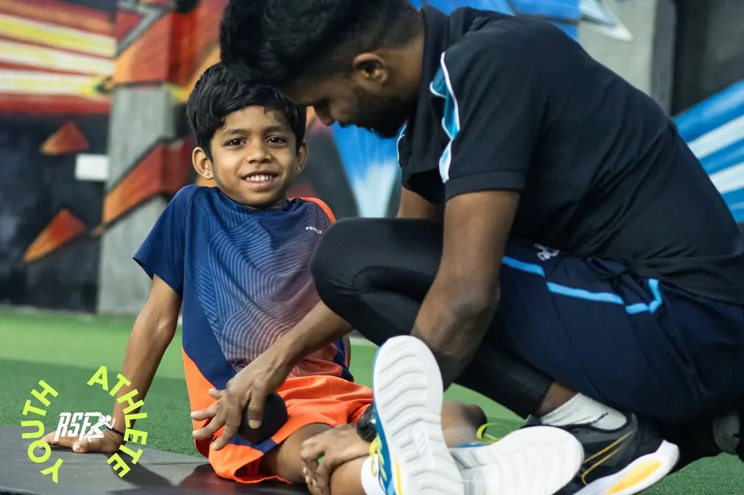 A crucial part of my coaching philosophy is connection. Here, one of my expert coaches works closely with a young athlete, ensuring he feels supported and understood. This personal guidance helps build confidence and makes the hard work of training an enjoyable process.