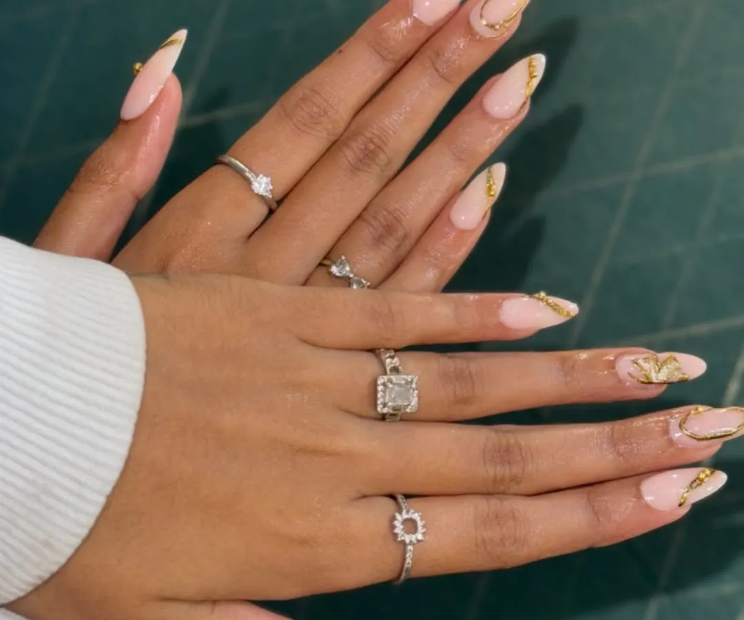 Get a closer look at this elegant nail set. I've crafted these long, almond-shaped extensions with a soft nude base and finished them with delicate gold foil accents. It's a perfect example of custom nail art that's both classy and on-trend.
