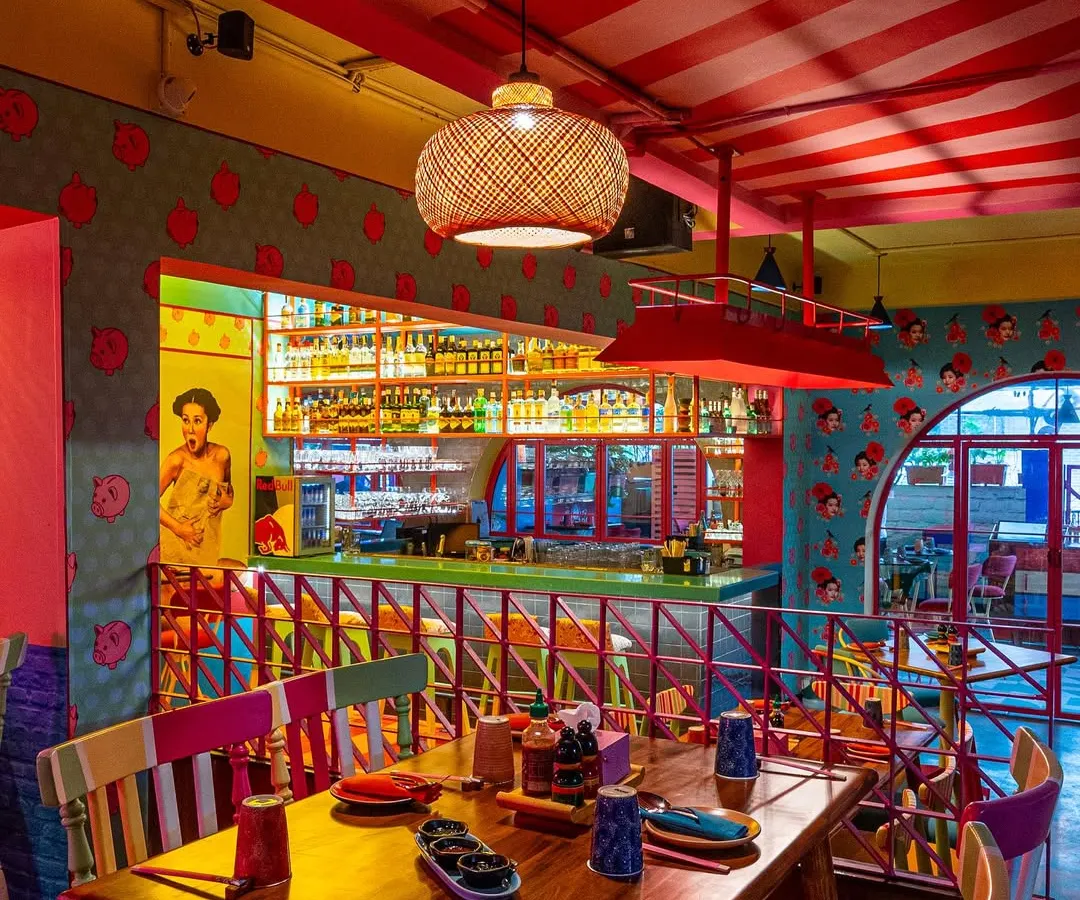 For The Fatty Bao, the goal was to capture its vibrant, high-energy personality. This shot highlights the eclectic mix of colors, from the red-striped ceiling to the pop-art graphics and the brightly lit bar, showing how I capture the unique character of a brand.