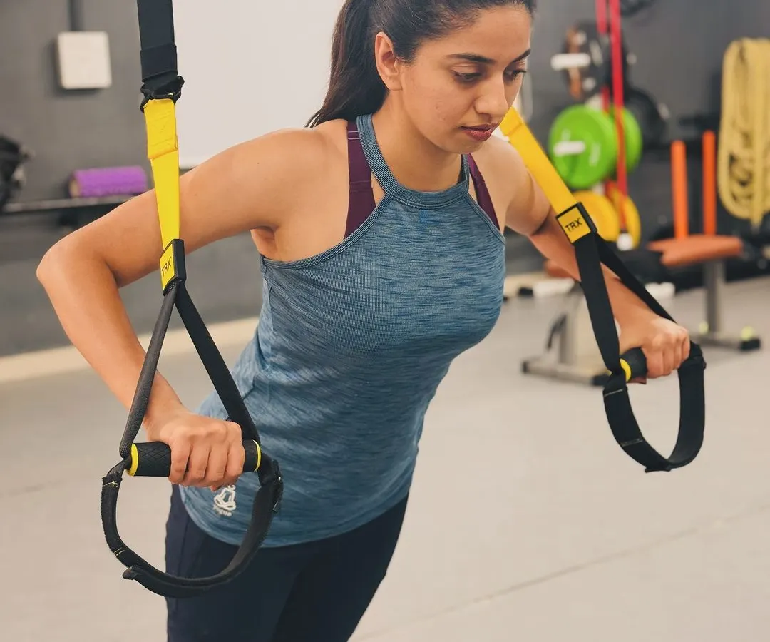 Strength training is for everyone. Here, I am demonstrating a TRX push-up, a fantastic exercise for building core and upper body strength safely and effectively.