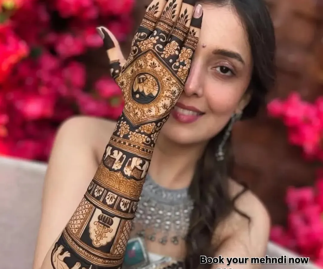 A happy bride is my biggest reward. Here, you can see the beautiful blend of traditional motifs like elephants and jharokhas with intricate patterns. This is a perfect example of a royal bridal mehndi design that looks stunning in photos.