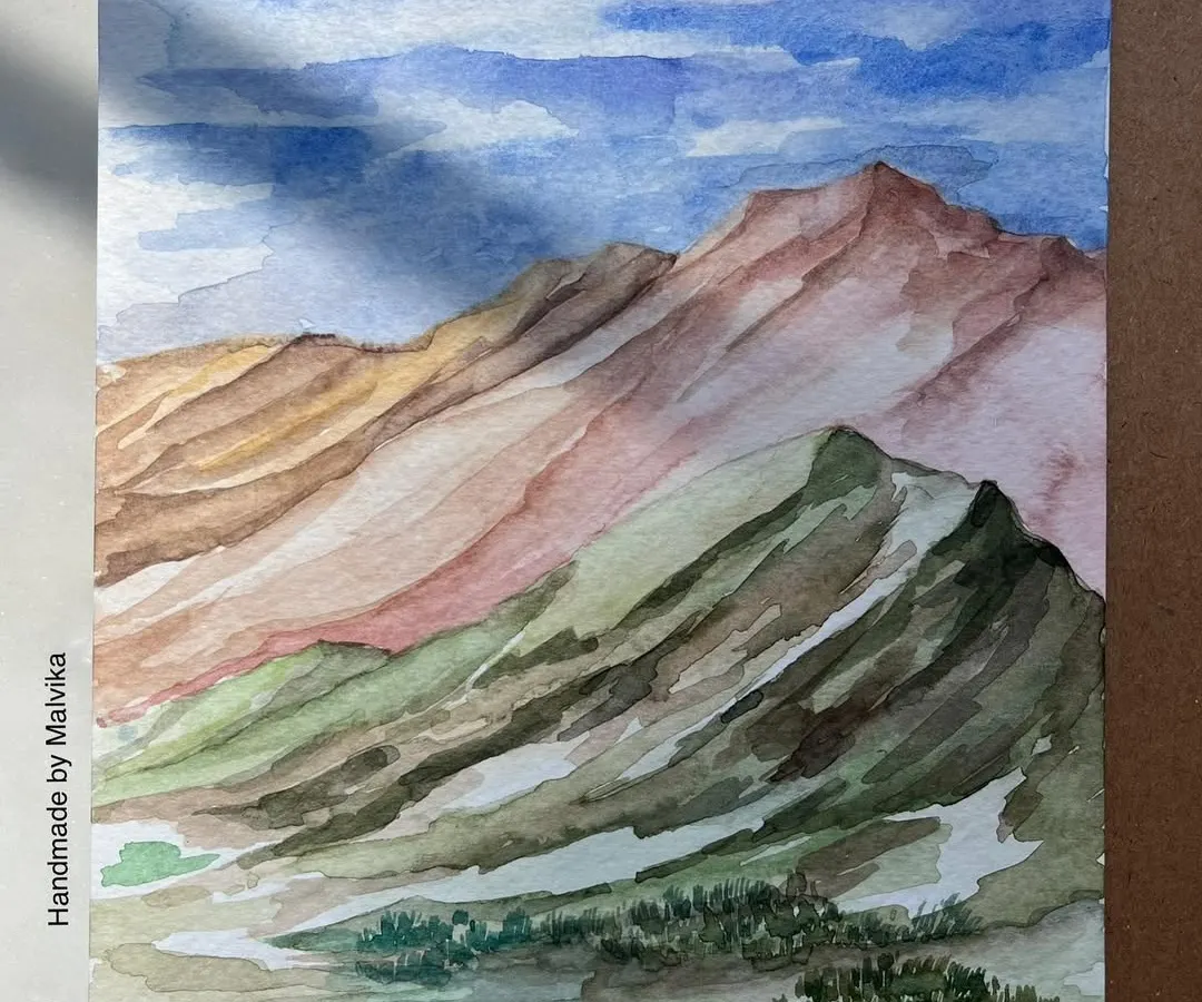 I often return to the mountains in my paintings. This watercolor piece captures the feeling of a clear day in the Himalayas, with layers of pink and green hills under a vast blue sky. It’s a moment of peace, painted from memory and available as a print.