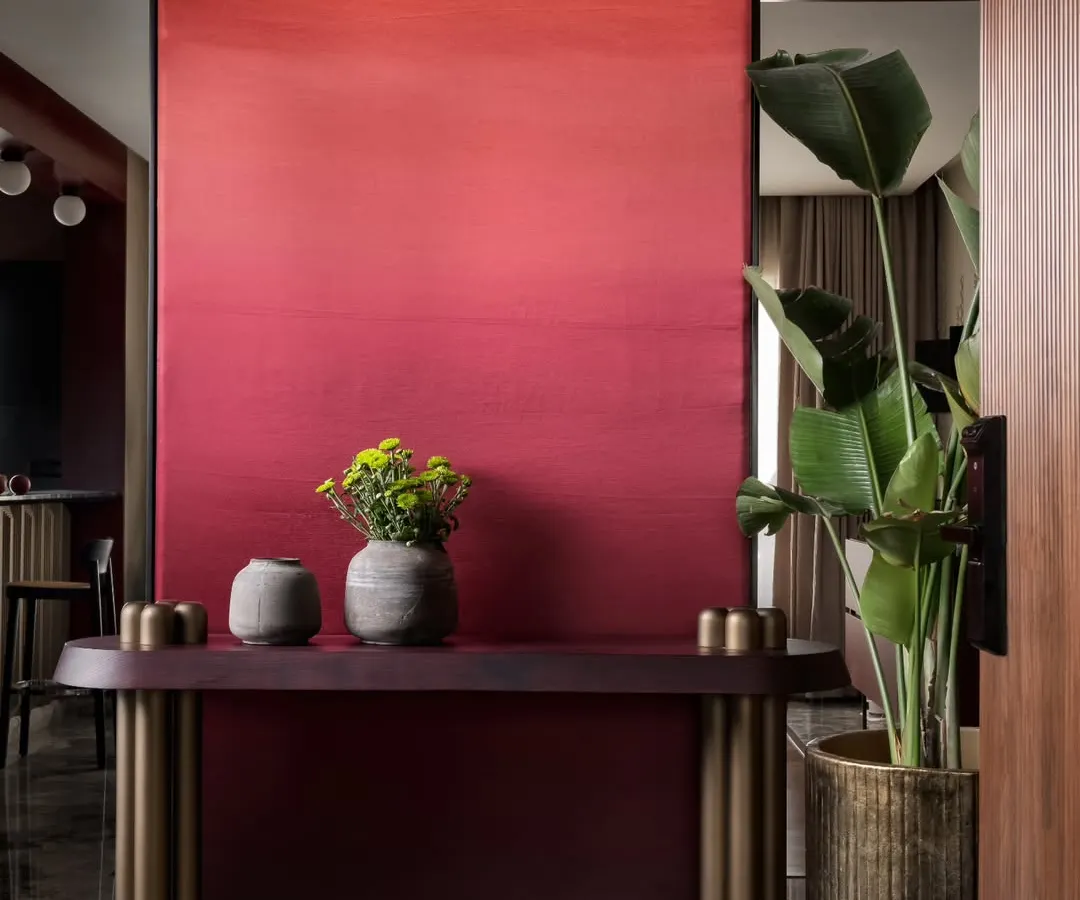 We believe in making bold statements. The foyer of our Scarlet Horizon project features a dramatic, hand-painted ombré wall that transitions from deep crimson to a vibrant scarlet. This entryway console and greenery create a powerful first impression that is both artistic and welcoming.