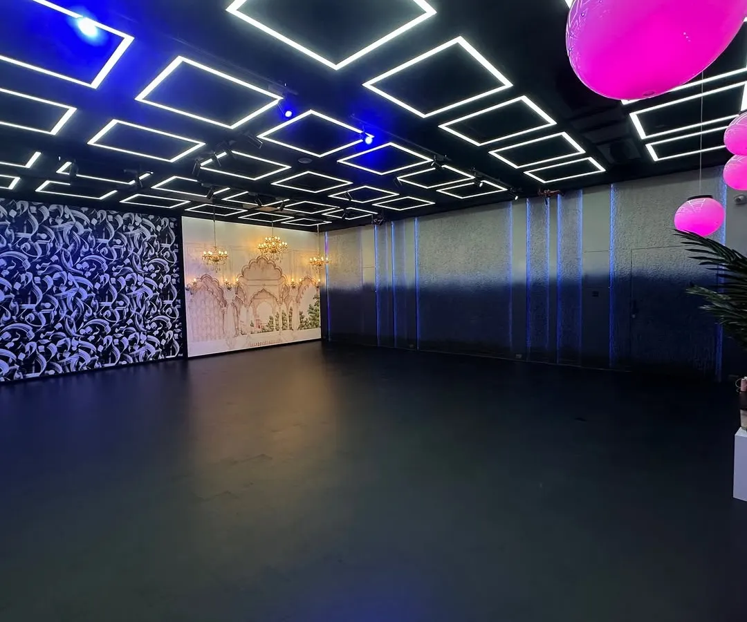 Take a look at the possibilities. This wide shot shows our main production floor where you can see the Haveli set, abstract art panels, and our signature geometric LED ceiling grid all in one frame. We designed this space so you can switch between completely different looks in minutes.